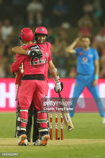 Josh Philippe of the Sydney Sixers and team mate Tom Curran celebrate winning over Adelaide Strikers during the Big Bash League match between the...