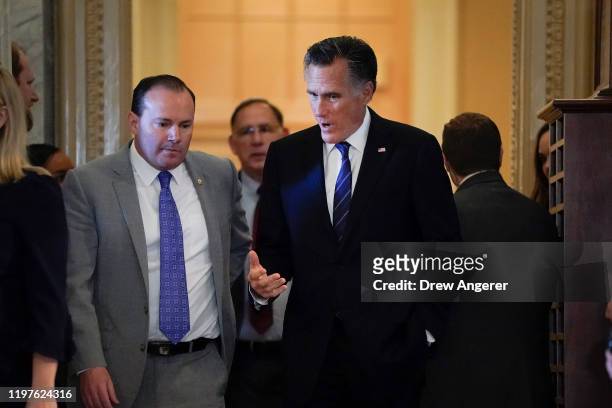 Sen. Mike Lee and Sen. Mitt Romney talk as they arrive at the Senate chamber for the Senate impeachment trial of U.S. President Donald Trump...