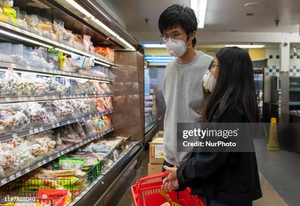 People wear 3M masks while shopping at a grocery store in Cupertino, California, United States on January 23, 2020 before the start of Lunar New...