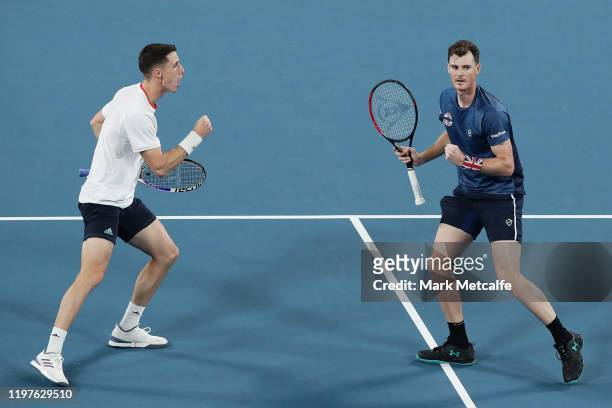 Jamie Murray and Joe Salisbury of Great Britain celebrate winning set point during their Group C doubles match against Sander Gille and Jordan...