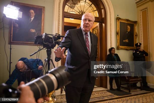 Sen. Patrick Leahy gestures to a group of photographers as he leaves the Senate floor during a recess in the Senate impeachment trial of President...