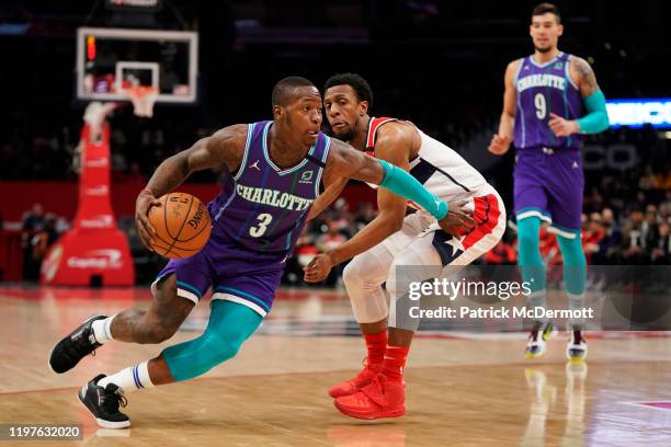 Terry Rozier of the Charlotte Hornets dribbles the ball against Ish Smith of the Washington Wizards in the first half at Capital One Arena on January...