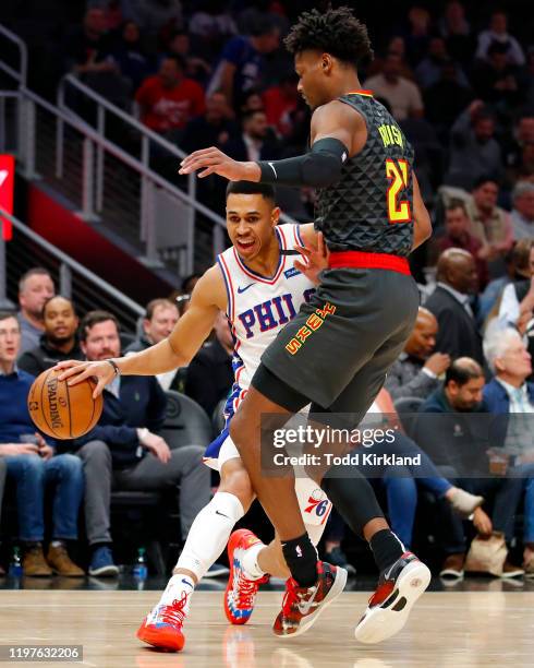 Zhaire Smith of the Philadelphia 76ers drives to the basket around Cam Reddish of the Atlanta Hawks during the first half of an NBA game at State...