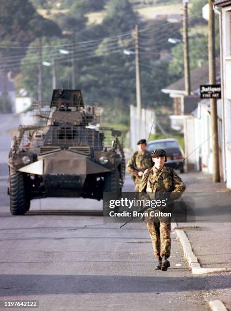 British soldiers and a armoured saracen vehicle patrol on the streets of Crossmaglen, County Armagh, Northern Ireland, in September 1981. The region...