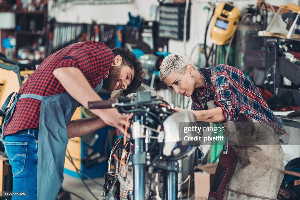 Couple Of Mechanics Working Together High-Res Stock Photo - Getty Images