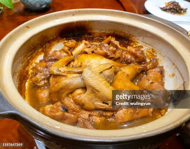 stewed whole chicken with pig trotter in casserole - chicken stew stock pictures, royalty-free photos & images