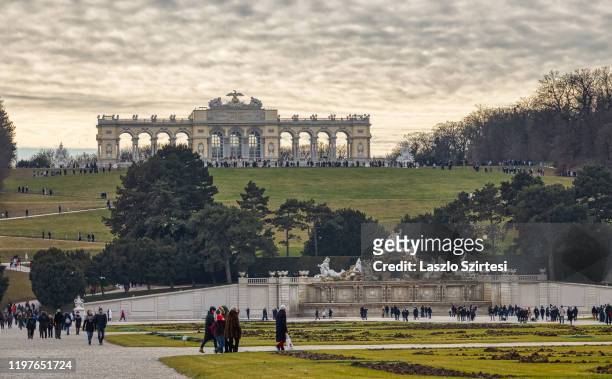 Tourists walk in the garden of the Schonbrunn Palace on December 30, 2019 in Vienna, Austria.