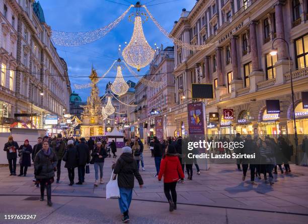 Tourists walk around the Plague Column at the Graben street on December 30, 2019 in Vienna, Austria.