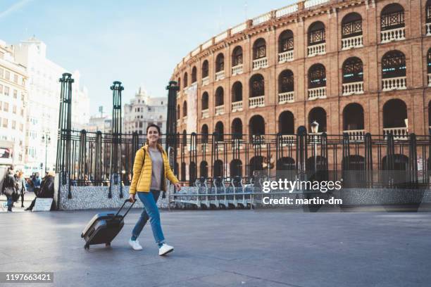 tourist woman visiting valencia, plaza de toros - carry on bag imagens e fotografias de stock