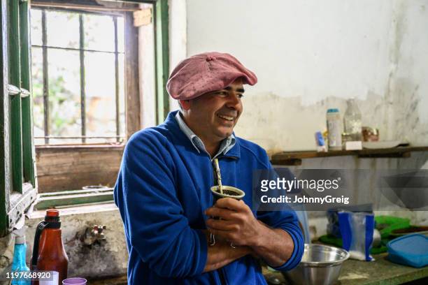 Smiling Argentine gaucho in late 40s relaxing with mate