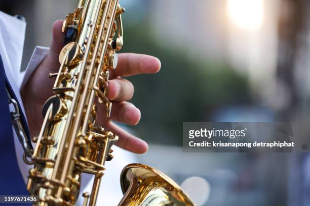 saxophone,international jazz day and world jazz festival. saxophone, music instrument played by saxophonist player musician in fest. - jazz stock-fotos und bilder