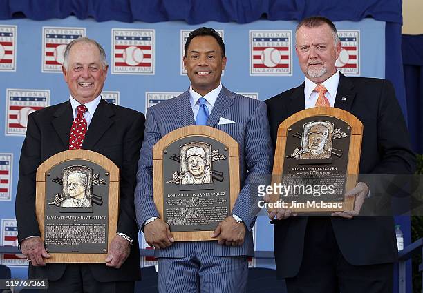 Pat Gillick, Roberto Alomar and Bert Blyleven pose with their plaques after their induction at Clark Sports Center during the Baseball Hall of Fame...
