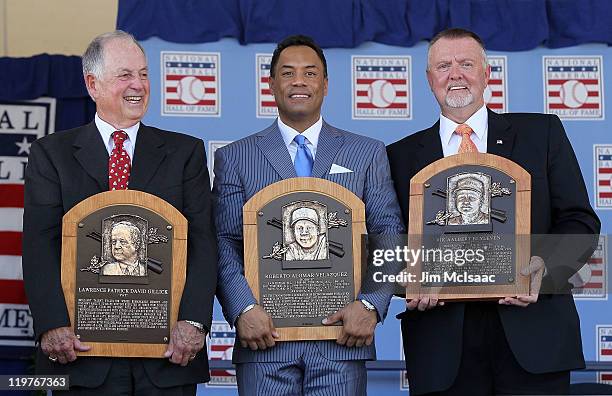 Pat Gillick, Roberto Alomar and Bert Blyleven pose with their plaques after their induction at Clark Sports Center during the Baseball Hall of Fame...