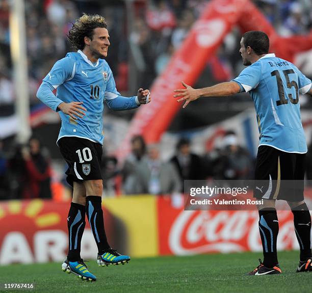 July 24: Diego Forla and Diego Perez celebrate after scoring against Paraguay during 2011 Copa America soccer final match at Monumental stadium on...