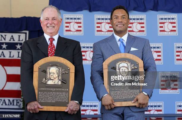 Pat Gillick and Roberto Alomar pose with their plaques after their induction at Clark Sports Center during the Baseball Hall of Fame induction...