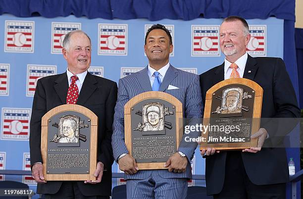 Pat Gillick, Roberto Alomar and Bert Blyleven pose with their plaques after their induction at Clark Sports Center during the Baseball Hall of Fame...