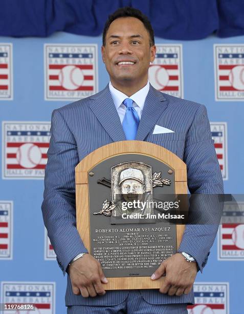 Roberto Alomar poses with his plaques at Clark Sports Center during the Baseball Hall of Fame induction ceremony on July 24, 2011 in Cooperstown, New...