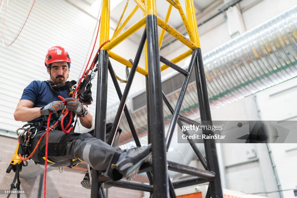 Telecommunication manual high worker engineer climbing an antenna