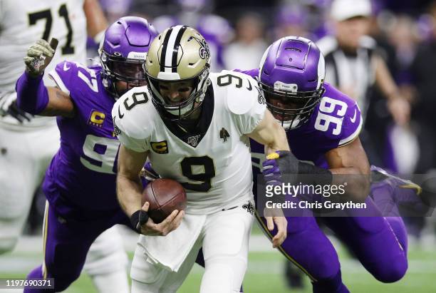 Everson Griffen and Danielle Hunter of the Minnesota Vikings sack Drew Brees of the New Orleans Saints during the first quarter in the NFC Wild Card...