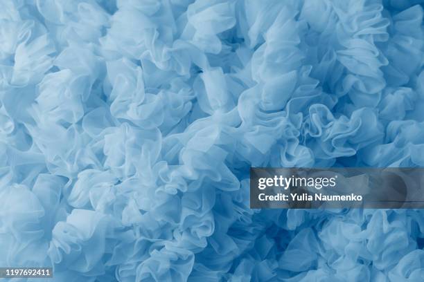 blue lightweight fabric mesh, texture of the fabric, beautifully draped background. - vestido azul fotografías e imágenes de stock