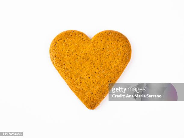 heart shaped ginger cookie against white background - heart candy on white stock pictures, royalty-free photos & images