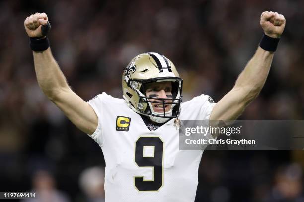 Drew Brees of the New Orleans Saints celebrates after a second quarter rushing touchdown by Alvin Kamara a against the Minnesota Vikings in the NFC...