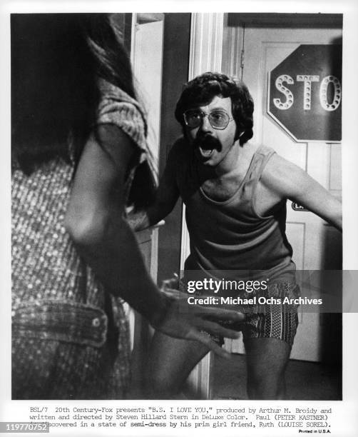 Louise Sorel catches Peter Kastner in a state of semi-dress in a scene from the film 'B.S. I Love You', 1971.