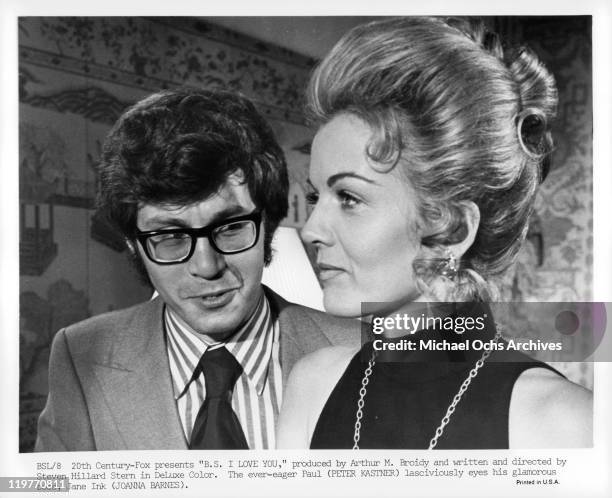 Peter Kastner eyes his glamorous boss Joanna Barnes in a scene from the film 'B.S. I Love You', 1971.