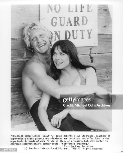 John Calvin holds Tanya Roberts in a scene from the film 'California Dreaming', 1978.