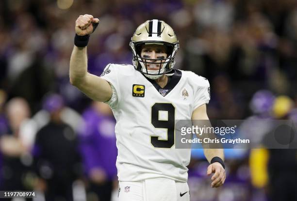 Drew Brees of the New Orleans Saints celebrates after throwing a touchdown pass to Taysom Hill during the fourth quarter against the Minnesota...