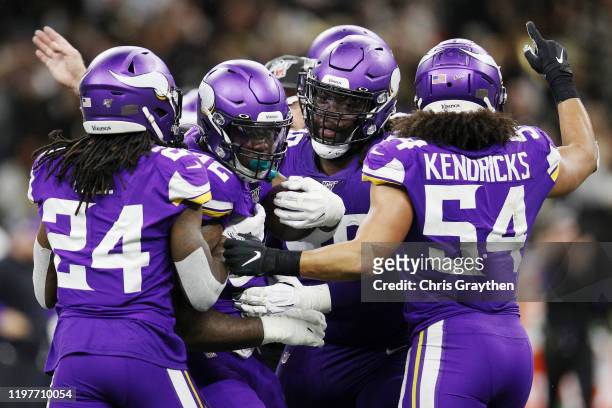 Jalyn Holmes of the Minnesota Vikings celebrates with teammates after recovering a fumble during the fourth quarter against the New Orleans Saints in...