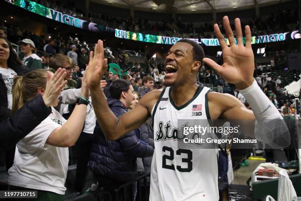 Xavier Tillman of the Michigan State Spartans celebrates a 87-69 win over the Michigan Wolverines with fans at the Breslin Center on January 05, 2020...