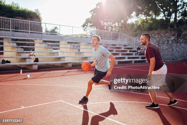 basketball players on court - jump shot stock pictures, royalty-free photos & images