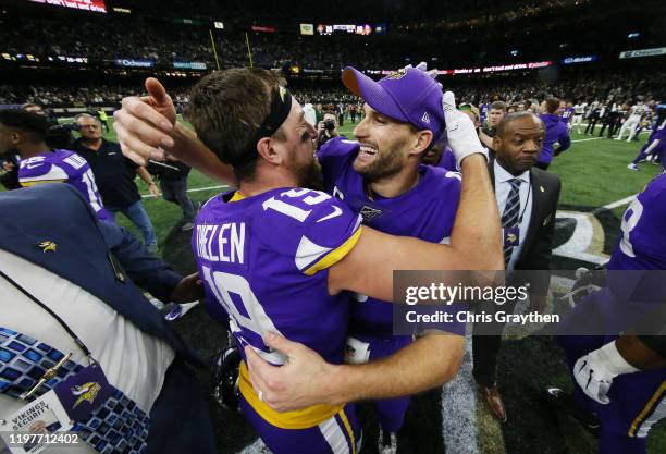 Kirk Cousins of the Minnesota Vikings celebrates with Adam Thielen after defeating the New Orleans Saints 26-20 during overtime in the NFC Wild Card...