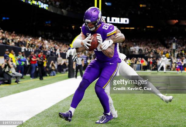 Kyle Rudolph of the Minnesota Vikings makes the game-winning touchdown reception against P.J. Williams of the New Orleans Saints during overtime in...