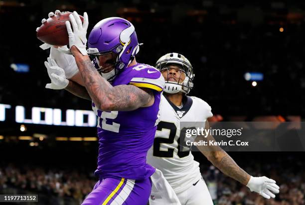 Kyle Rudolph of the Minnesota Vikings makes the game-winning touchdown reception against P.J. Williams of the New Orleans Saints during overtime in...