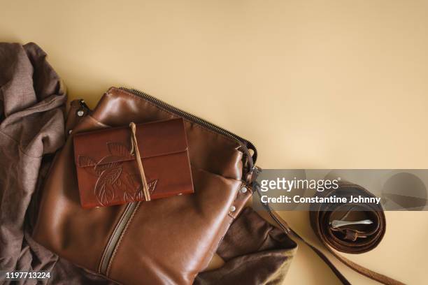 still life of satchel bag and personal diary - satchel bag stock pictures, royalty-free photos & images