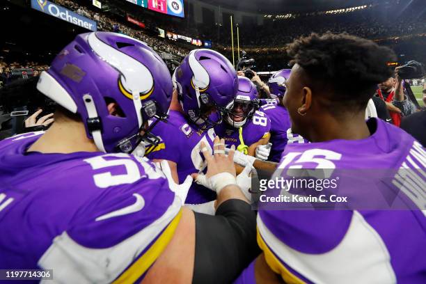 Kyle Rudolph of the Minnesota Vikings celebrates with teammates after catching the game-winning touchdown reception against P.J. Williams of the New...