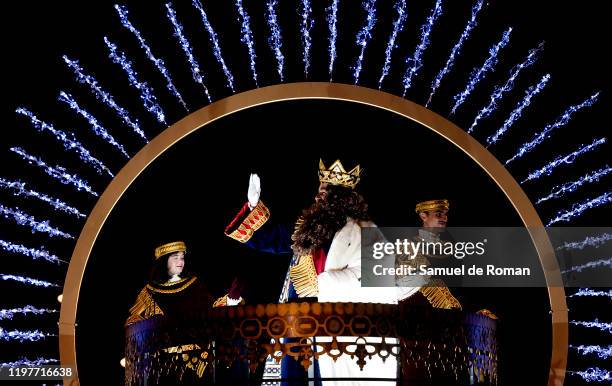 Performer dressed as Gaspar King waves his hand to the public as he rides a float during the 'Cabalgata de Reyes,' or the Three Kings paradeon...
