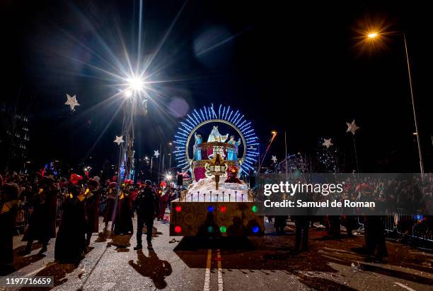 Performer dressed as Melchoir King waves his hand to the public as he rides a float during the 'Cabalgata de Reyes,' or the Three Kings paradeon...