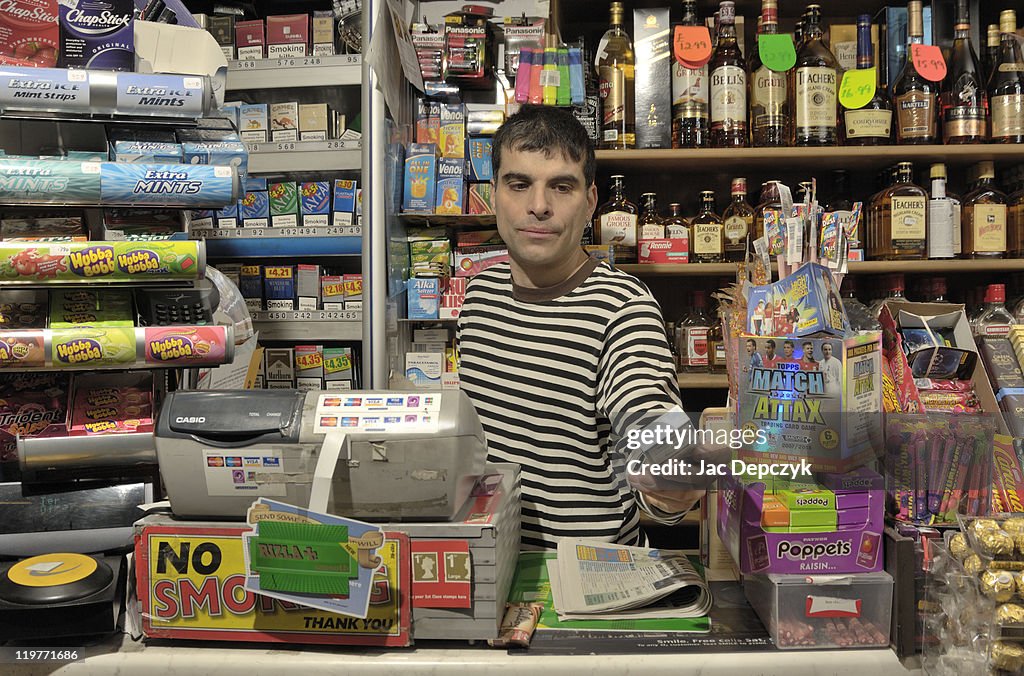 Convenience store owner handing over cigarettes.