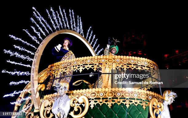 Performer dressed as Baltasar King waves his hand to the public as he rides a float during the 'Cabalgata de Reyes,' or the Three Kings paradeon...