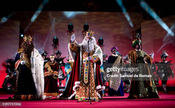 Performers dressed as Baltasar King, Gaspar King and Melchoir King wave his hand to the public as he rides a float during the 'Cabalgata de Reyes,'...
