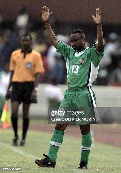 Nigerian player Tijani Babangida waves as he enters the pitch 23