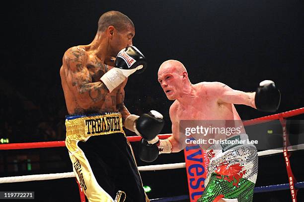 Jason Cook throws a punch at Ashley Theophane during the British Light welterweight Title fight at Wembley Arena on July 23, 2011 in London, England.