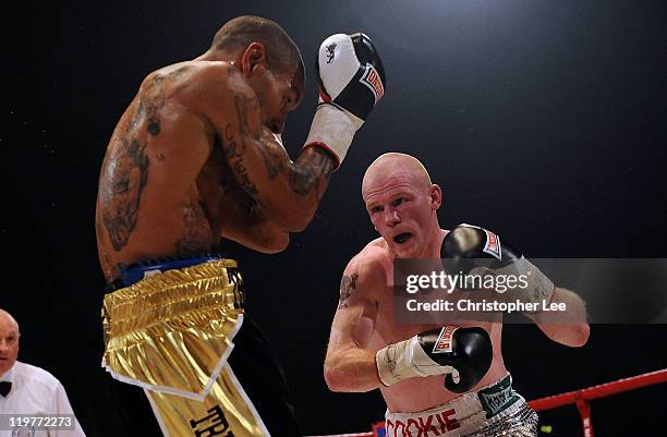 Jason Cook throws a punch at Ashley Theophane during the British Light welterweight Title fight at Wembley Arena on July 23, 2011 in London, England.