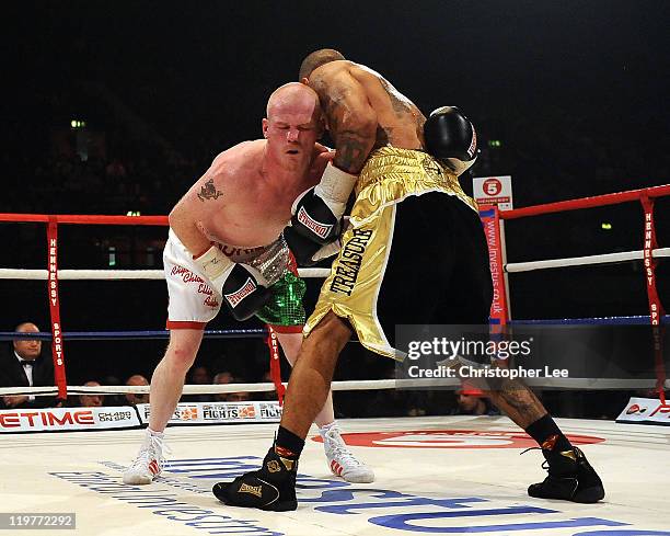 Jason Cook pulls a face as it seems Ashley Theophane hits below the belt during the British Light welterweight Title fight at Wembley Arena on July...