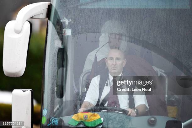 Person in a protective suit is seen sitting behind the driver of one of the coaches transporting eighty-three Britons and 27 foreign nationals who...