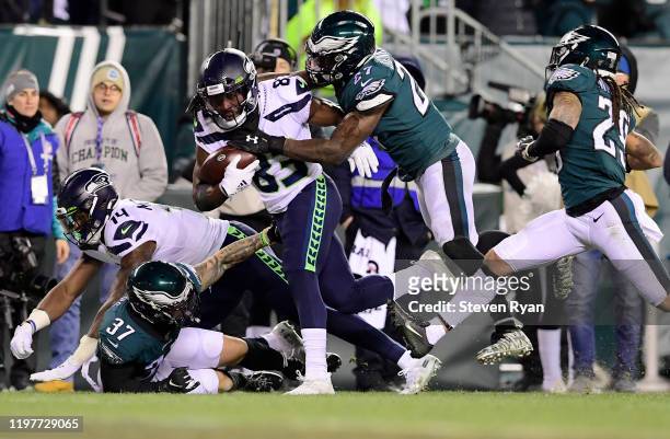 David Moore of the Seattle Seahawks carries the ball against Malcolm Jenkins of the Philadelphia Eagles during the NFC Wild Card Playoff game at...
