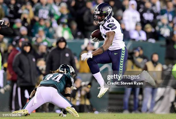 David Moore of the Seattle Seahawks carries the ball against Cre'von LeBlanc of the Philadelphia Eagles during the NFC Wild Card Playoff game at...